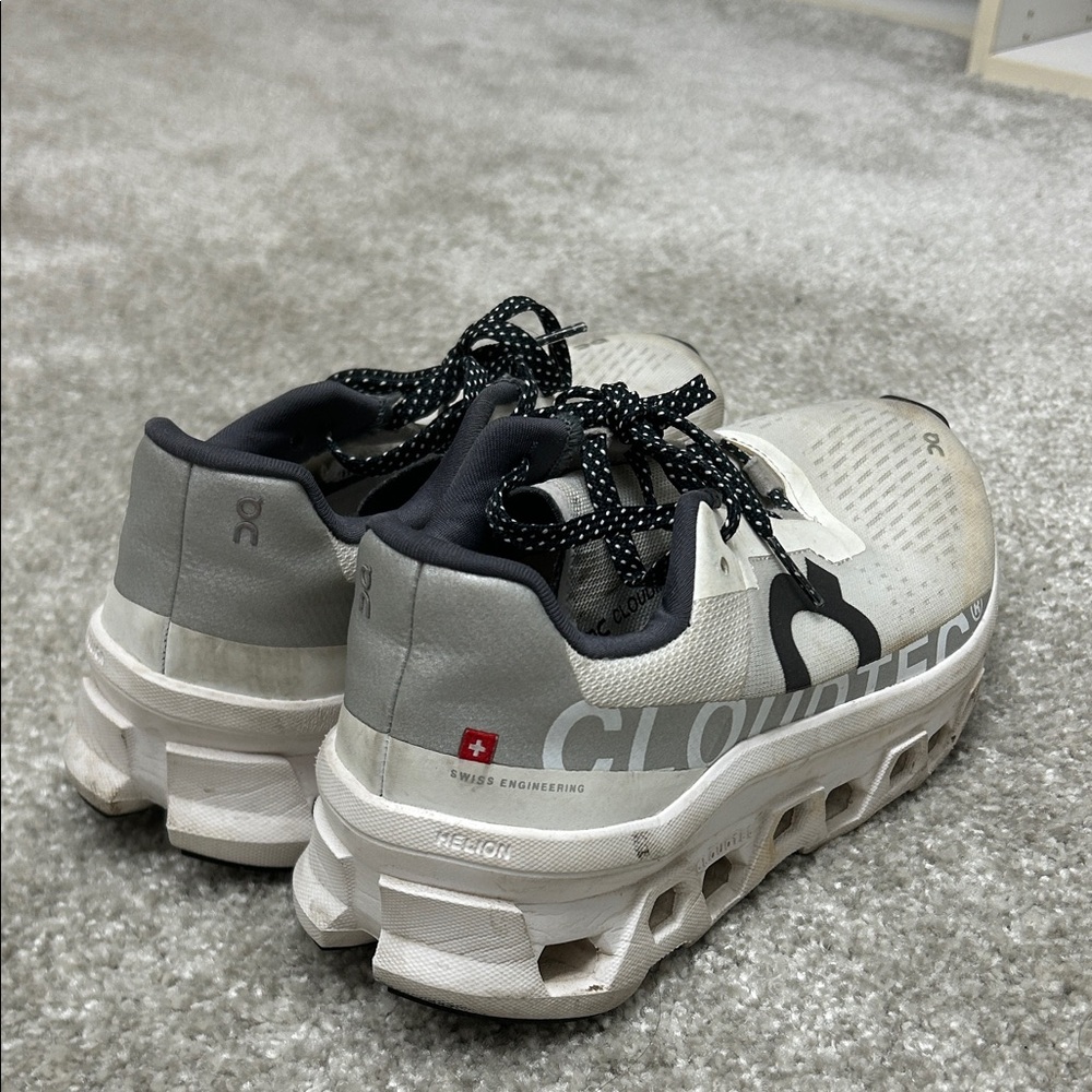 On Running Cream and Black Athletic Shoes